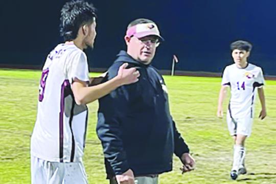 Crescent City Junior-Senior High School boys soccer player Jeremiah Carbajal prepares to hug head coach Jeff Lease after the Raiders defeated host Daytona Beach Father Lopez Thursday night for Lease’s 100th career victory, all at Crescent City. (MARK BLUMENTHAL / Palatka Daily News)