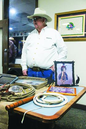 SARAH CAVACINI/Palatka Daily News. George DeLoach displays rodeo memorabilia and Florida cowboy history on Thursday during the One Book One Putnam kickoff event. 
