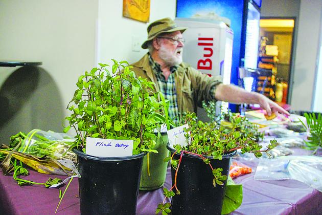 SARAH CAVACINI/Palatka Daily News. Palmer Kinser, who represented the Garden Club of Palatka, explains to One Book One Putnam attendees about the types of edible or non-edible Florida plants on Thursday. 