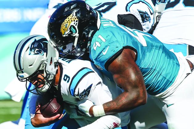 Jacksonville’s Josh Allen (41) takes down Carolina quarterback Bryce Young for one of his three sacks on Sunday. (JOHN STUDWELL / Special to the Daily News)