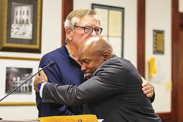 SARAH CAVACINI/Palatka Daily News – Palatka City Manager Troy Bell, right, hugs St. Johns County Commissioner Henry Dean after being sworn in during Thursday’s Palatka City Commission meeting.
