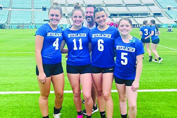 From left, Madisynn Guessford, Camryn Link, Paislee Guessford and Tinley Guessford pose for a picture before Interlachen’s flag football preseason event at EverBank Stadium on Feb. 16. Behind them is Rams flag football coach Erik Gibson. (Submitted photo)