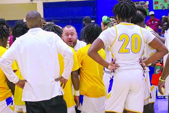 Palatka boys basketball coach Bryan Walter talks to his team during a timeout in Saturday’s District 5-4A championship victory. (RITA FULLERTON / Special to the Daily News)