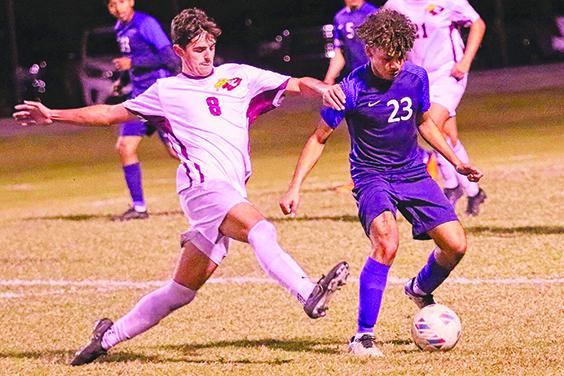Crescent City’s David Newbold tries to get the ball away from Pierson Taylor’s Danny Carballo in the second half of Wednesday’s district championship. (RITA FULLERTON / Special to the Daily News)