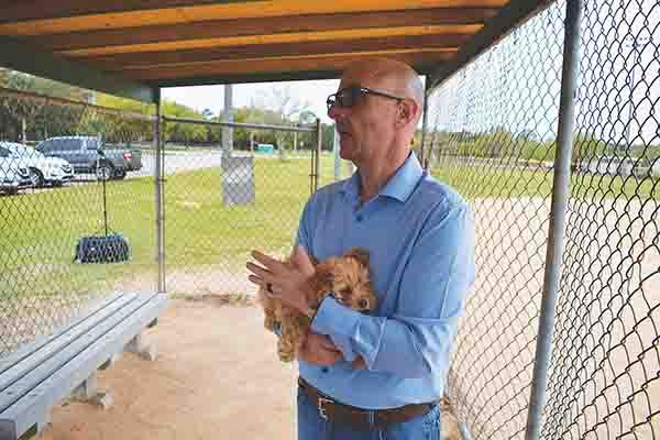 BRANDON D. OLIVER/Palatka Daily News – Putnam County Sheriff’s Office Col. Joe Wells holds one of about 100 dogs that were taken from an Interlachen residence Wednesday.