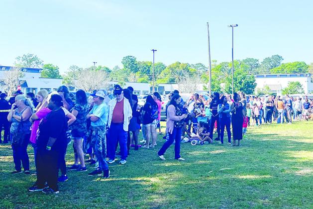 A line of people backs up toward the Putnam County Governmental Complex parking lot on Friday morning as these hopefuls wait to adopt new dogs rescued from an Interlachen property this week. (SARAH CAVACINI / Palatka Daily News)