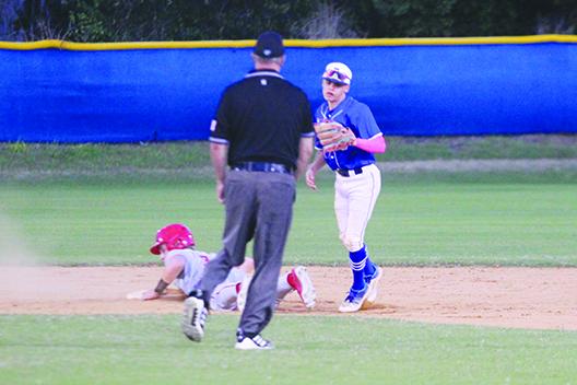 Palatka second baseman Tanner Ortiz shows the ball to the umpire after tagging out Santa Fe base runner Cooper Ruppert on an attempted steal. (MARK BLUMENTHAL / Palatka Daily News)