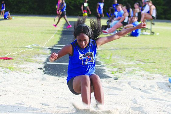 Palatka’s Destiny Williams lands in the sand after completing an attempt in the triple jump. The freshman won both the triple jump and high jump. (MARK BLUMENTHAL / Palatka Daily News)