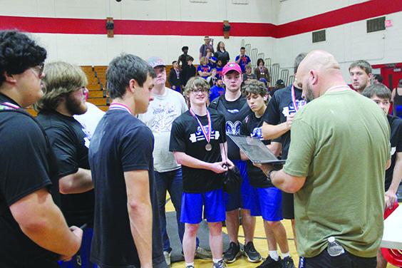 Interlachen boys weightlifting coach Tad DeLoach looks at his laptop and talks to his team after the District 8-1A meet where the host Rams finished third overall. (COREY DAVIS / Palatka Daily News)