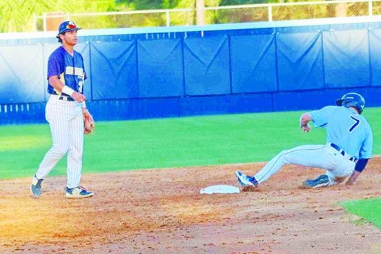 St. Johns River State College’s Tripp Davis slides safely into second base after a wild pitch on Tuesday as Seminole’s Paul Napolitano waits for a throw to be sent to him. (RITA FULLERTON / Special to the Daily News)