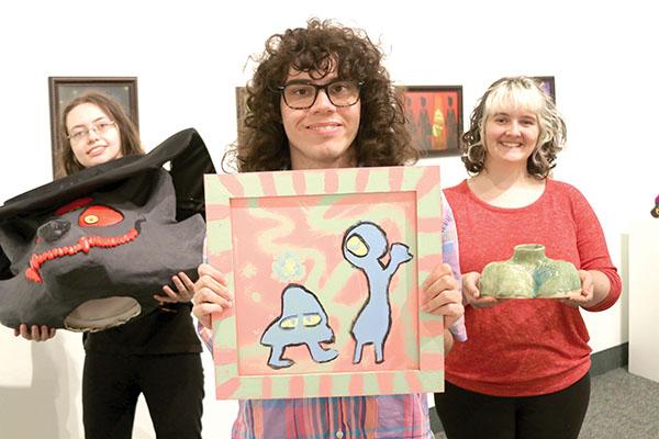 TRISHA MURPHY/Palatka Daily News – Florida School of the Arts students, from left, Vanessa Heymanowski, Trey Meyers and Brynn Lacouture hold some of their artworks that will be on display at the school’s Graduate Exhibition, which begins Thursday.