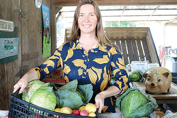 TRISHA MURPHY/Palatka Daily News – Jena Dennis pays a visit to the County Line stand near Hastings on Friday to check on the produce items that are the mainstay for the return of the Hastings Cabbage, Potato and Bacon Festival, which will take place next weekend. 