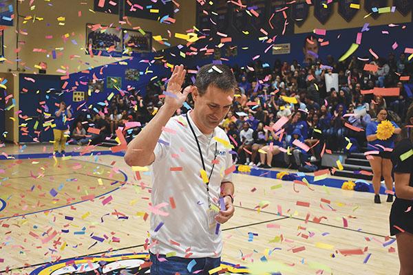 BRANDON D. OLIVER/Palatka Daily News – Michael Chaires, an assistant principal at Palatka Junior-Senior High School, waves to students and colleagues through a cloud of confetti Friday during a celebration of him being named Florida’s Assistant Principal of the Year.
