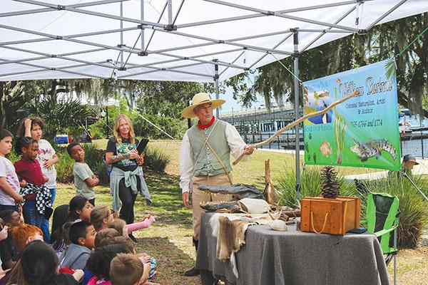 SARAH CAVACINI/Palatka Daily News – Browning-Pearce Elementary School teacher Tabby Wall looks on as her class learns about William Bartram from Mike Adams, who portrayed the famed explorer Wednesday during the Bartram Frolic.