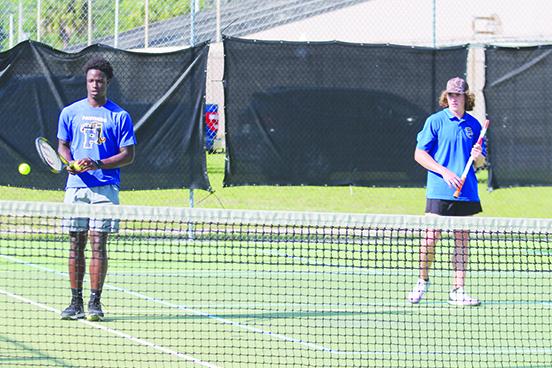 Palatka’s Trenton Williams (left) tries to handle a ball hit to him between points as first doubles partner Cullen Sloan watches him during a match April 2 against Baker County. (MARK BLUMENTHAL / Palatka Daily News)