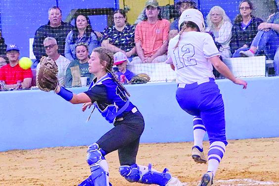 Palatka’s Haleigh Faulkner scores on a first-inning fielder’s choice groundball as Peniel Baptist catcher Allie Peacock collects the throw. (RITA FULLERTON / Special to the Daily News)