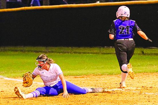 Peniel Baptist Academy’s Traelyn Baker beats out an infield single as Palatka first baseman Zoey Clark is forced to do the splits to get to the ball. The ball got past Clark and allowed Peniel’s Lexi Peacock to score the only run the Warriors would collect Thursday night in Palatka’s 12-1 triumph over Peniel at Palatka in the Putnam County Tournament championship game. (RITA FULLERTON / Special to the Daily News)