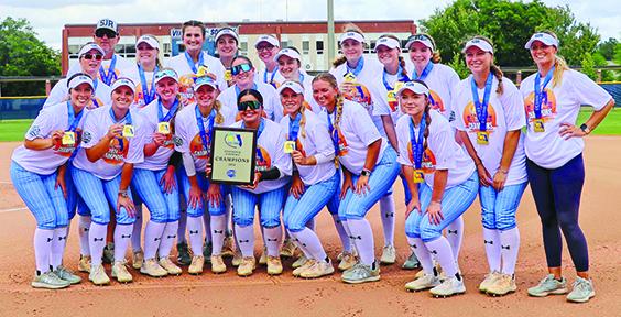 St. Johns River State College softball players and coaches celebrate their Sun-Lakes Conference regular-season title plaque during a ceremony in between games of a sweep Saturday against Pasco-Hernando State. (RITA FULLERTON / Special to the Daily News)