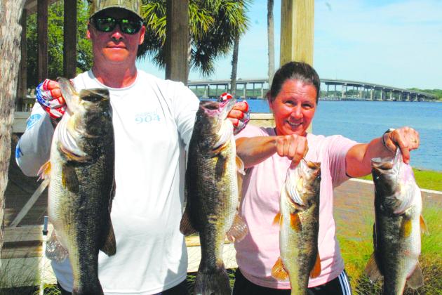 Brian and Michelle hold up their winning fish in the Andy Lawrence Open Bass Tournament. (GREG WALKER / Daily News correspondent)
