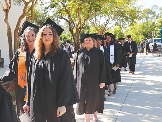 Photo submitted by Susan Kessler – Erin Jacobsen, foreground, and her mother, Shannon Jacobsen, left, prepare to participate in the St. Johns River State College spring commencement ceremony Friday.