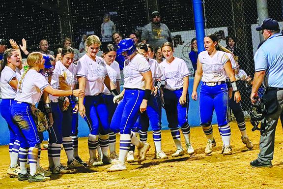 Palatka softball players greet Maddie Brown (7) at home plate after she hit a two-run home run during a seven-run fourth inning against Bradford on Tuesday. (RITA FULLERTON / Special to the Daily News)
