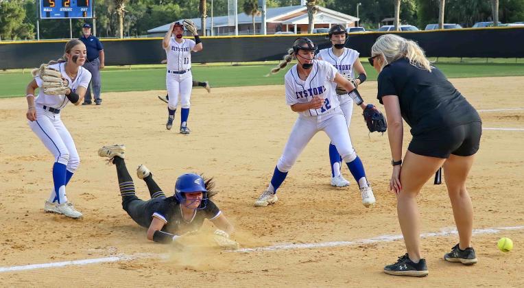 Palatka's Zoey Clark slides safely into third base after Keystone Heights botched a second-inning pickle play in Thursday's District 3-3A softball championship. (RITA FULLERTON / Special to the Daily News)
