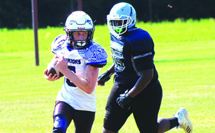 Peniel Baptist’s Andrew Dennin looks upfield against Newberry Christian in the spring game. (ANDY HALL / Palatka Daily News)