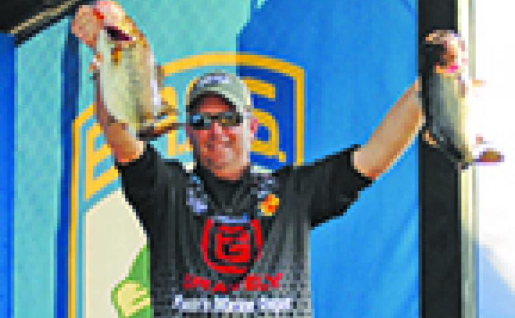 Cliff Prince holds up his fish at the BASS Elite in Palatka on the St. Johns River in February. (GREG WALKER / Special To The Daily News)