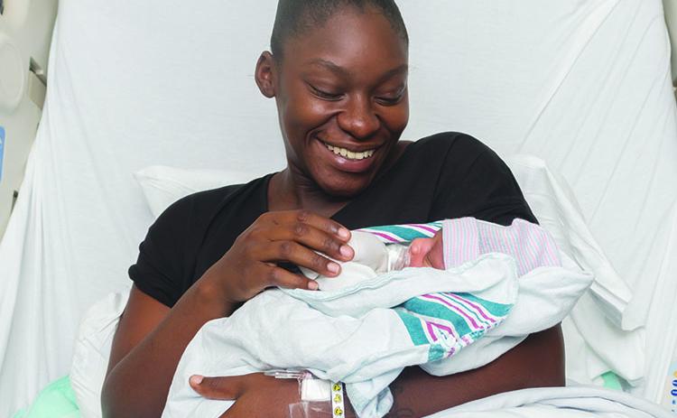 Kymara Boyd and Joziah William Fuller rest in the hospital a day after the child was born.