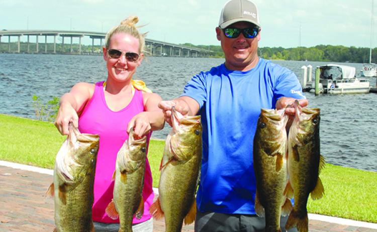 Katy Gray, left, and Lee Stalvey hold up their winning fish. (GREG WALKER / Special To The Daily News)