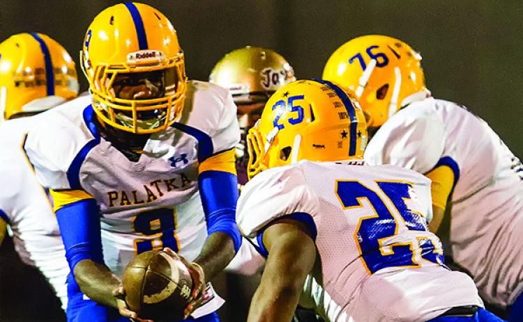 Palatka quarterback De'Abrie Smith hands off to running back Ja'Twan Honor during the 2013 matchup between Palatka and St. Augustine. (JOHN STUDWELL / Special To The Daily News) 
