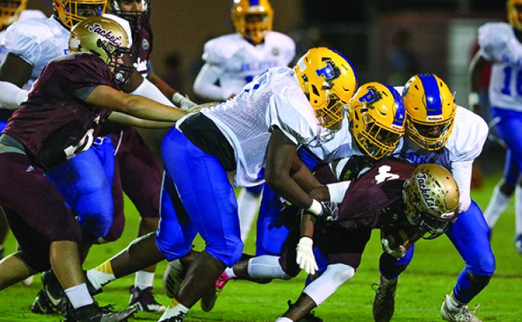 Palatka defenders Tavaris Scott, David Williams and DeShawn Shaw converge on a St. Augustine runner. (GREG OYSTER / Special To The Daily News)