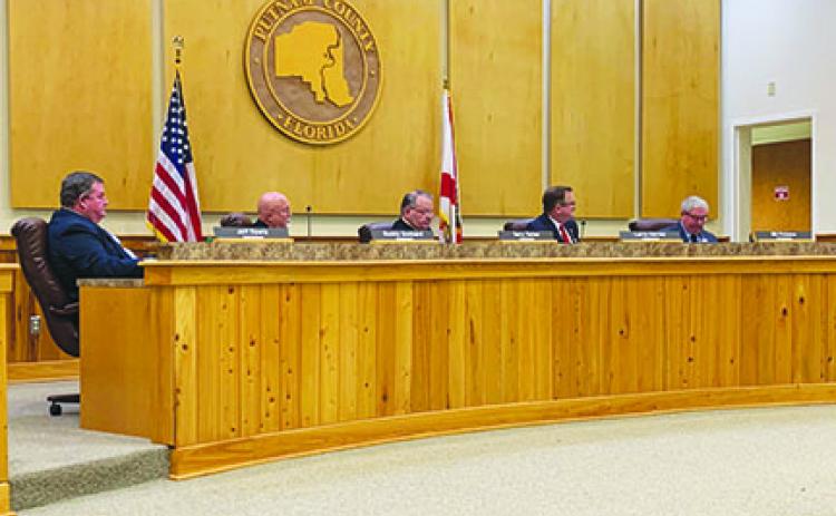 Putnam County commissioners discuss matters Tuesday at their meeting.