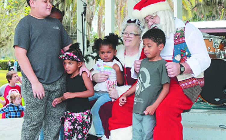 Children tell Santa and Mrs. Claus what they want for Christmas during last year's Christmas in the Park in Crescent City.