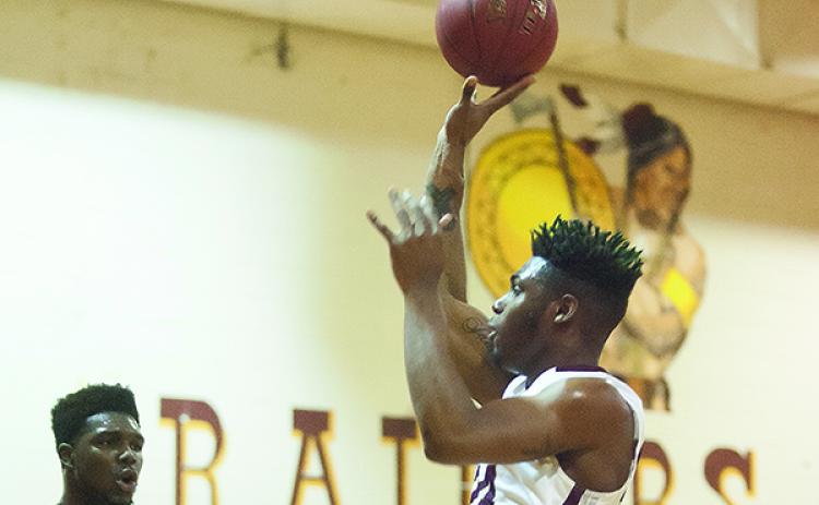 Crescent City's Datwan Lewis puts a shot up during the regional semifinal at home against Dixie County in 2016. (Daily News file photo)