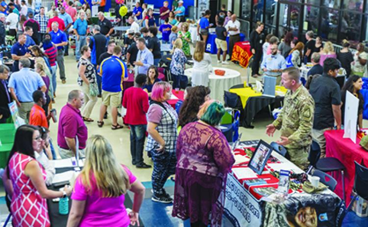 Students and their families talk with several businesses and college representatives at the Putnam County School District’s College & Career Fair in August at Palatka High School. Workforce development is considered crucial to the county’s future economic growth in retaining existing employers and recruiting new ones.