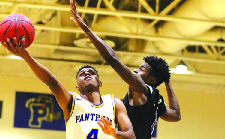 Palatka’s Jimmy Williams drives for two of his six points against Matanzas’ Joel Whittock. (GREG OYSTER / Special To The Daily News)