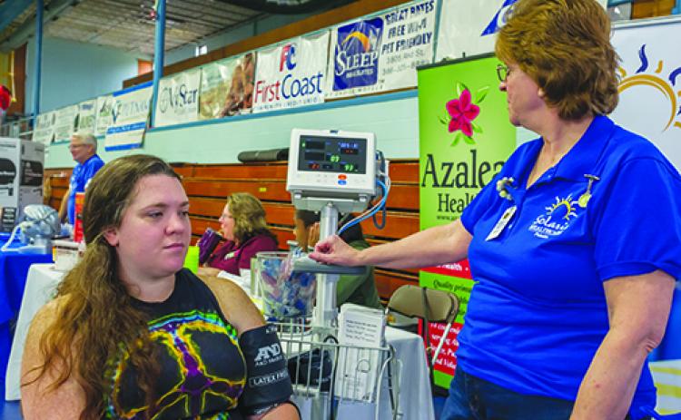 A blood pressure test is administered during last year's Rotary Health Fair.