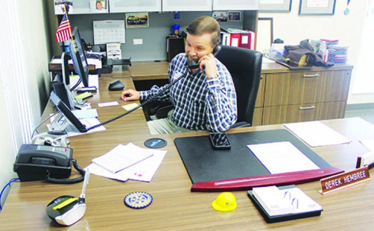Derek Hembree sits at his desk at the Clay Electric office in Palatka, where he is now the distrcit manager.