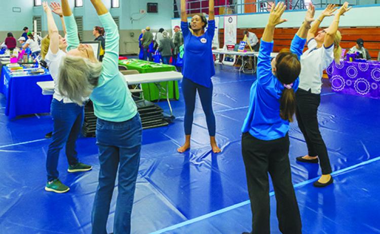 Volunteers teach yoga at last year's Rotary Health Fair.