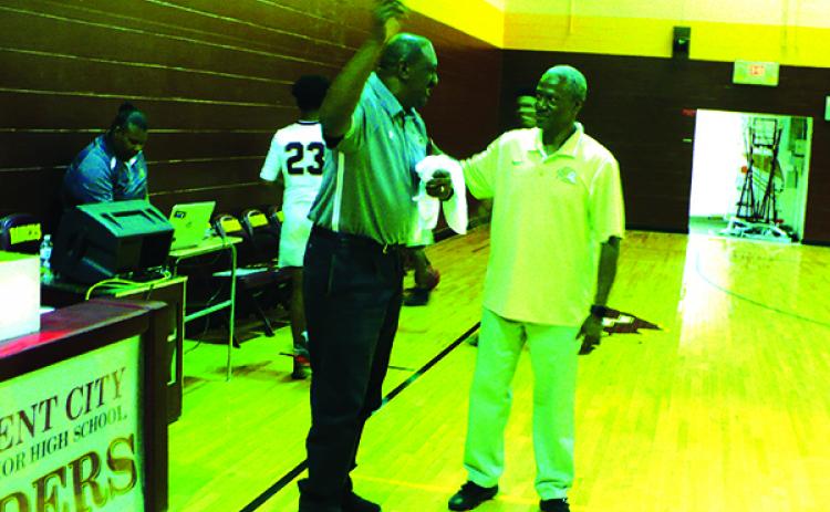 Crescent City High School boys basketball coach Al Carter talks with Fort Meade High head coach Otis Wilson after Carter's Raiders moved on in the District 8-1A Tournament, 68-47, on Monday night. (MARK BLUMENTHAL / Palatka Daily News)