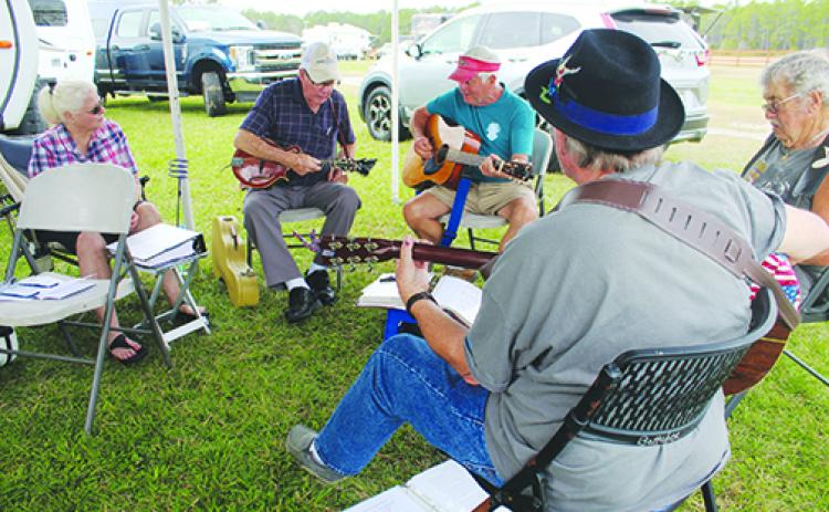 Bluegrass fans make music of their own before the Spring Palatka Bluegrass Festival.
