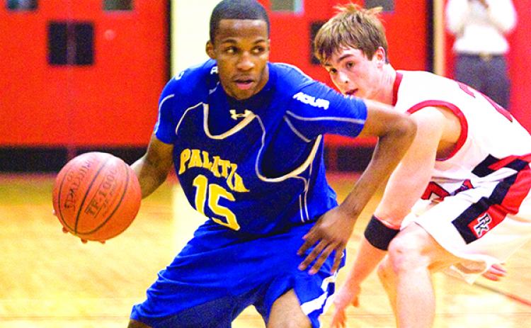 Palatka's Brandon Johnson looks to drive on Jacksonville Bishop Kenny's Travis Pate during the Region 1-4A first-round matchup on Feb. 18, 2010. (Daily News file photo)