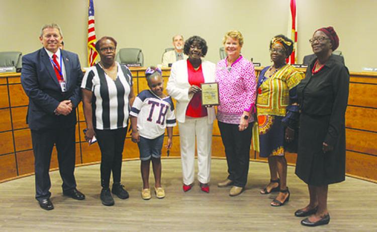 School board Chairwoman Sandra Gilyard celebrates her state certification with her family at Tuesday’s school board meeting.