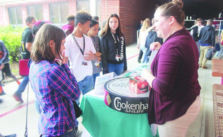 Catherine Crinnion, the Students Working Against Tobacco coordinator, prepares her Through With Chew Week display Wednesday at C.H. Price Middle School in Interlachen.
