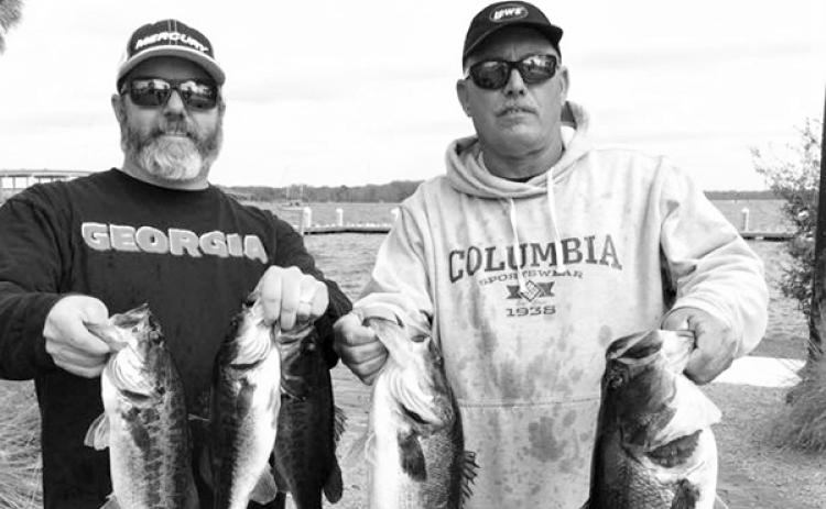 Platt Drew (left) and Rusty Fox hold up their winning fish. (GREG WALKER / Special To The Daily News)