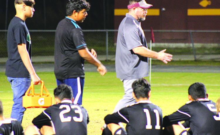 Crescent City High School boys soccer coach Jeff Lease (right) chats with his team at halftime of the Region 1-3A first-round match Wednesday against Jacksonville Episcopal. (MARK BLUMENTHAL / Palatka Daily News)
