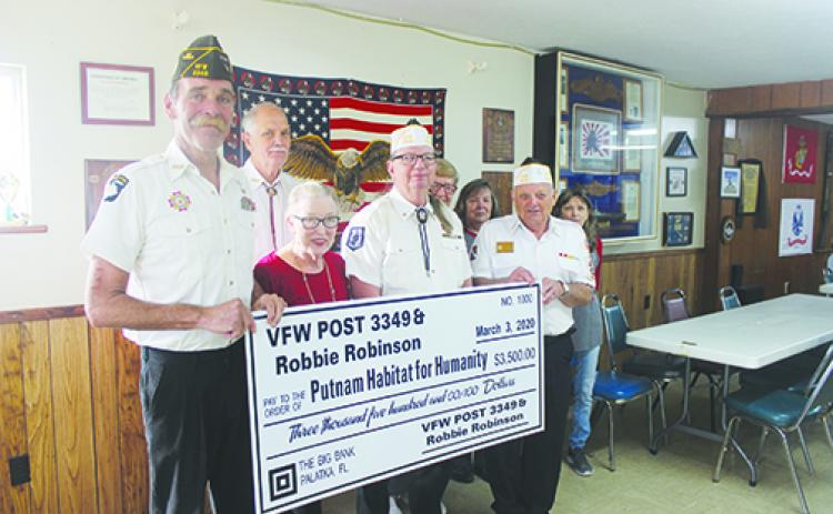 Members of Veterans of Foreign Wars Post 3349 in Palatka hold the $3,500 check the group is donating to Putnam Habitat for Humanity’s Veterans Village of Palatka on Monday.