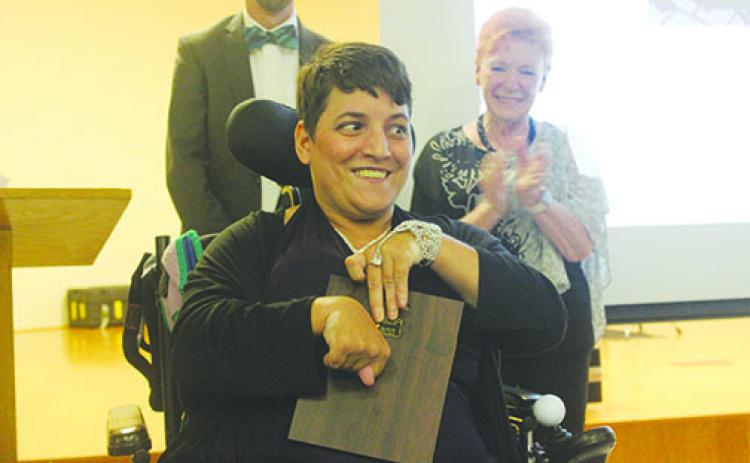 Latosha Obry receives the Eddie Mooney Award for her helpfulness and optimism on Thursday at Ravine Gardens State Park.