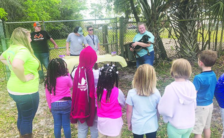 James A. Long Elementary School first-graders learn about goats Tuesday at Jenkins Middle School during the second annual Farm Day. 